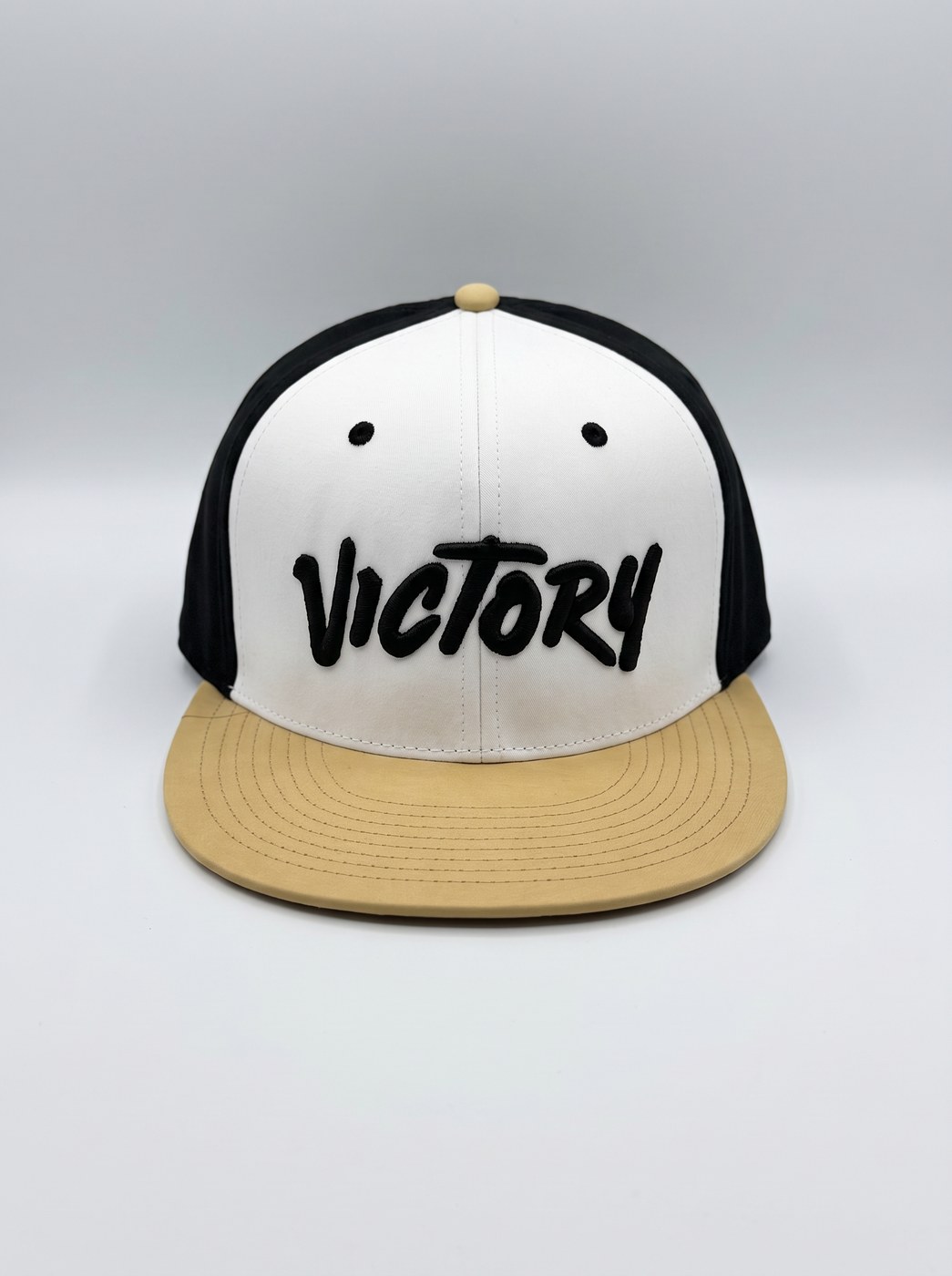 White Victory Softball cap with Vegas gold brim and black Victory brush-script embroidery
