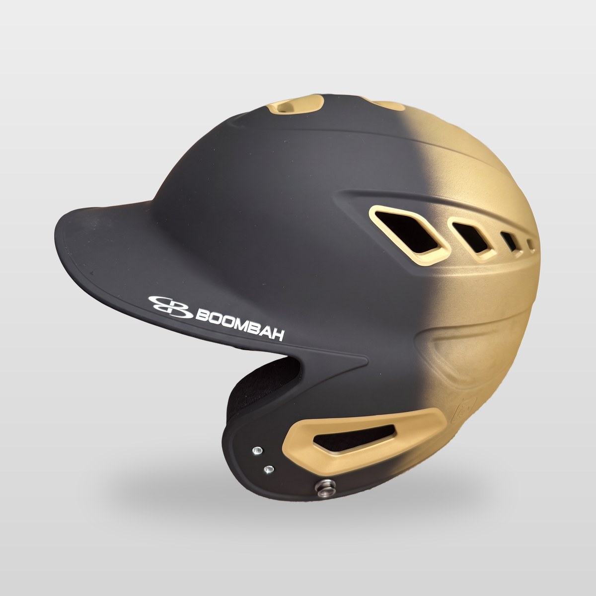 Boombah DEFCON batting helmet in matte black fading to Vegas gold